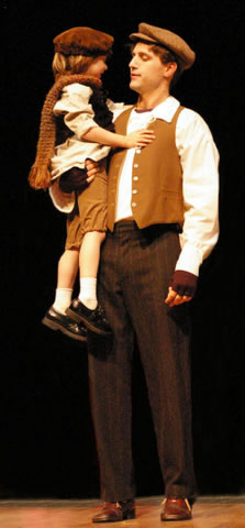 Bob Crachit holds Tiny Tim